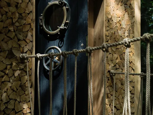 The porthole front door of the Woodsman's Treehouse