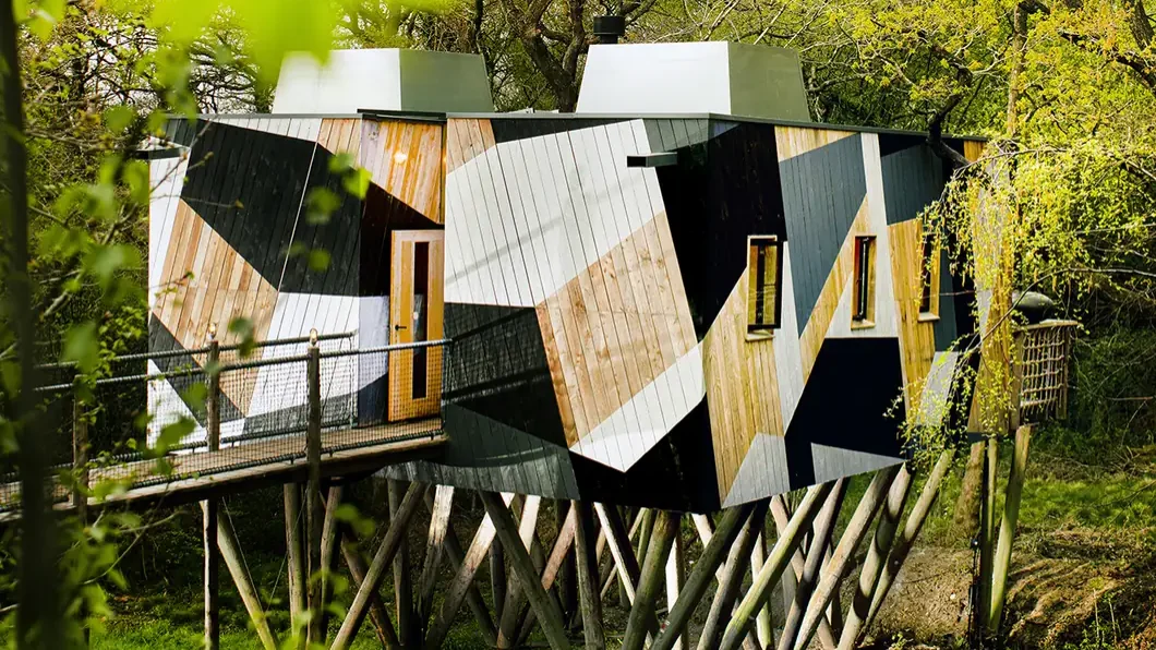 The Dazzle Treehouse on its stilts among the trees