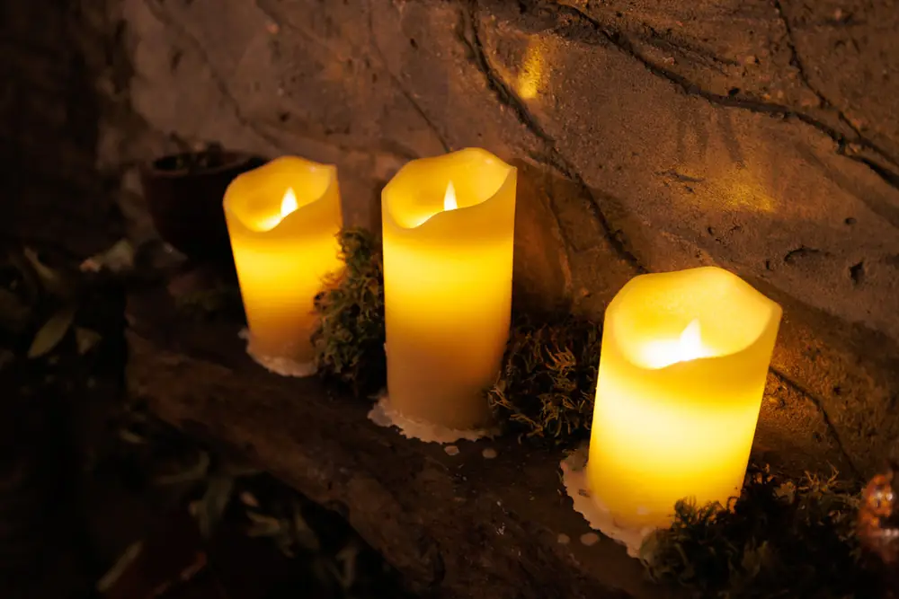 Candles set into the rock wall of Faun&rsquo;s Hideaway