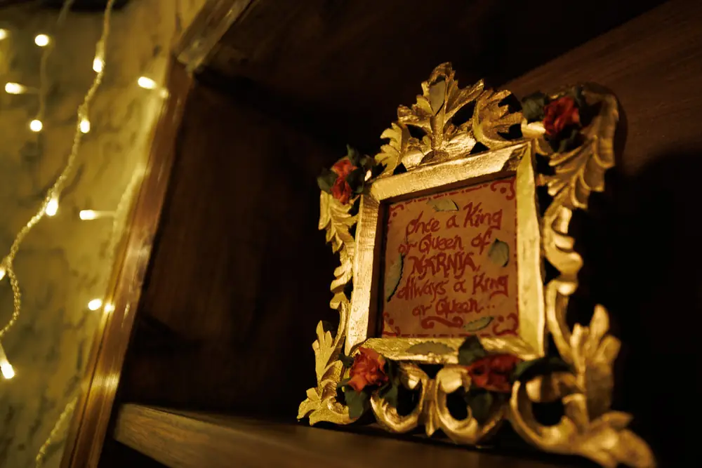 A gilded mirror and fairy lights in the treehouse