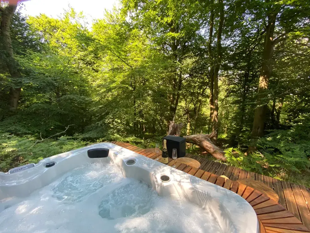 The jacuzzi set into the woodland decking